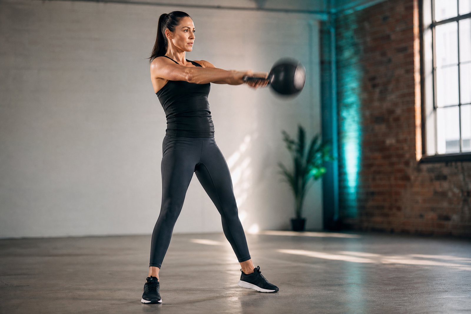 Kettlebell swing demonstrating safe HIIT frequency and strength training