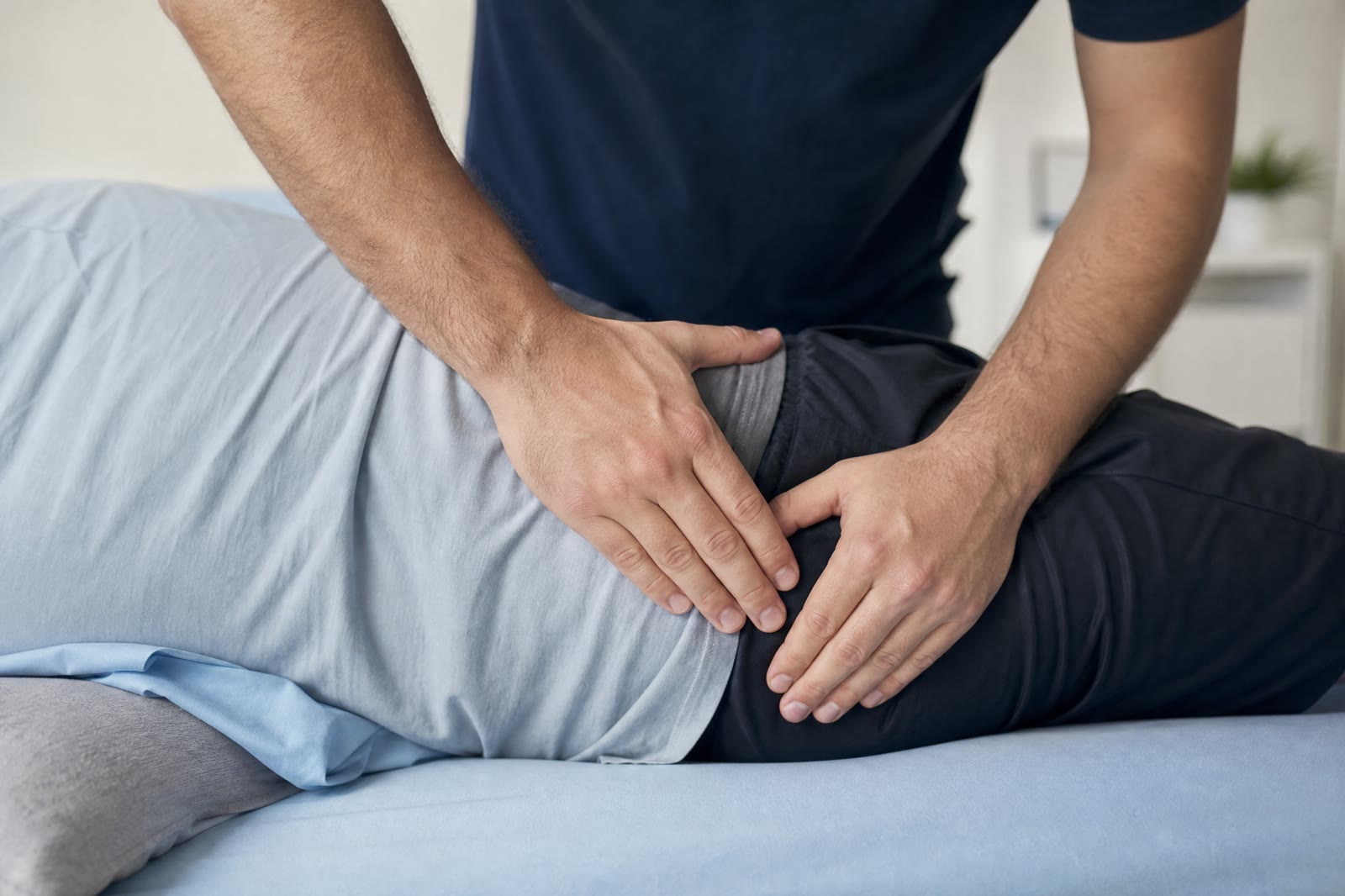 Physiotherapist performing manual therapy on a patient's lower back